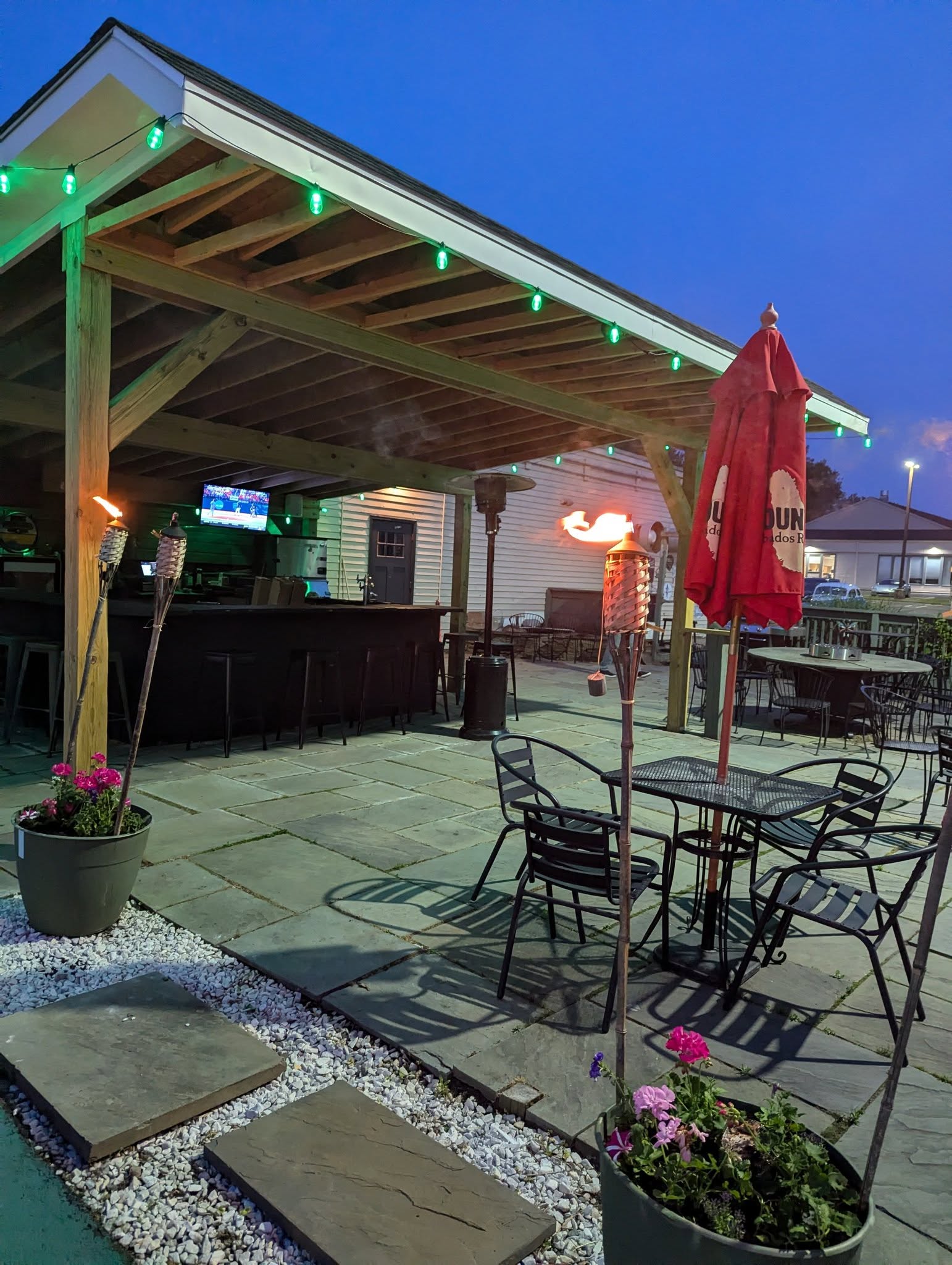 Longley's covered patio bar lit up at night in Branford CT